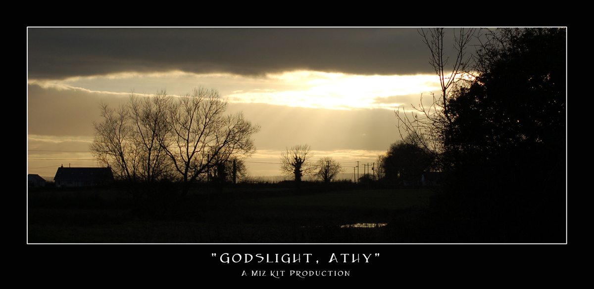 Sunlight breaks through the clouds in streams above Athy, Co Kildare, Ireland