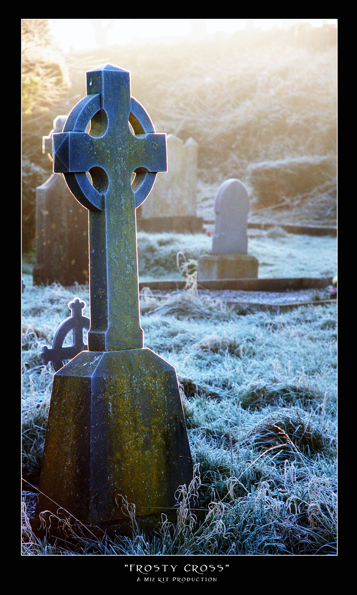 A rimfrosted Celtic cross glows in the sunrise.